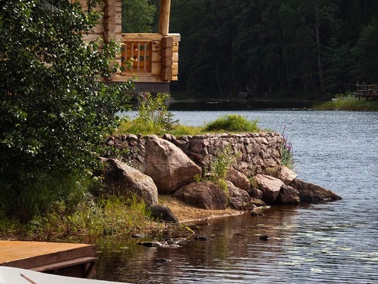 Two boats docked near a wooden cabin.