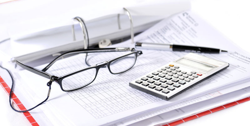 Calculator, glasses, and paperwork.