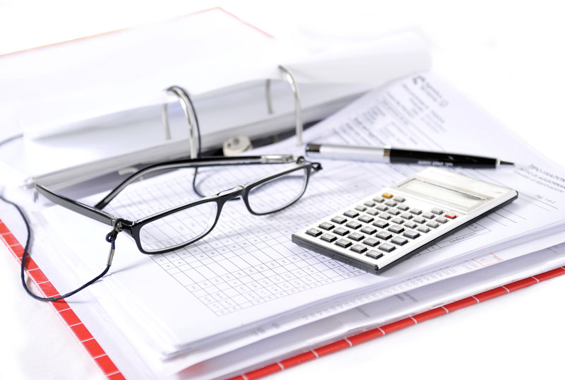 Calculator, glasses, and paperwork.