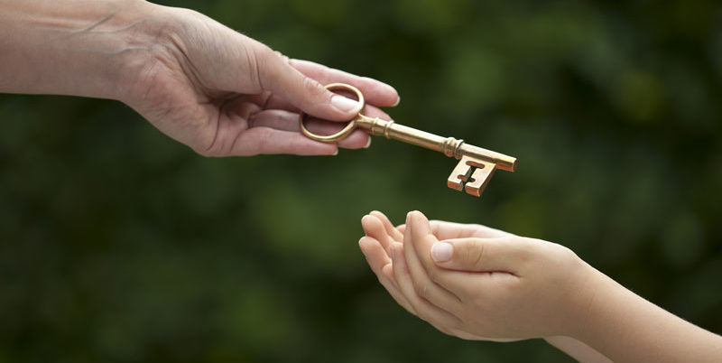 Handing a golden key to a child.