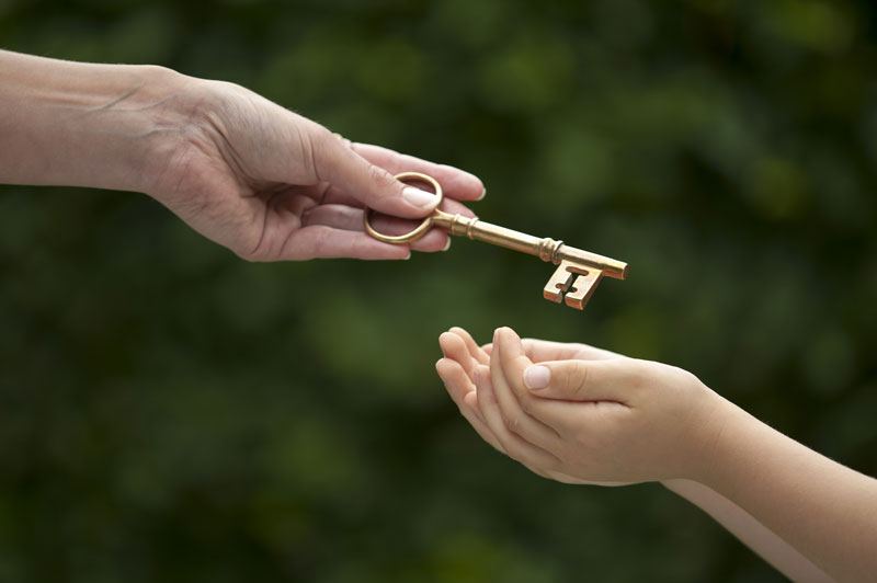 Handing a golden key to a child.