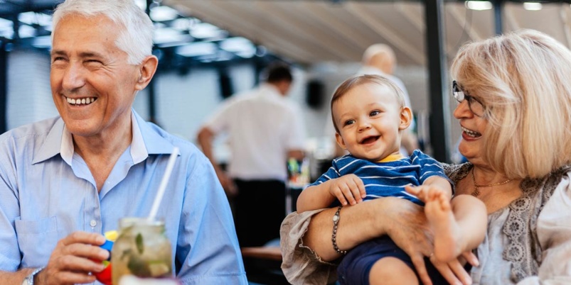 Smiling family enjoying a meal together.