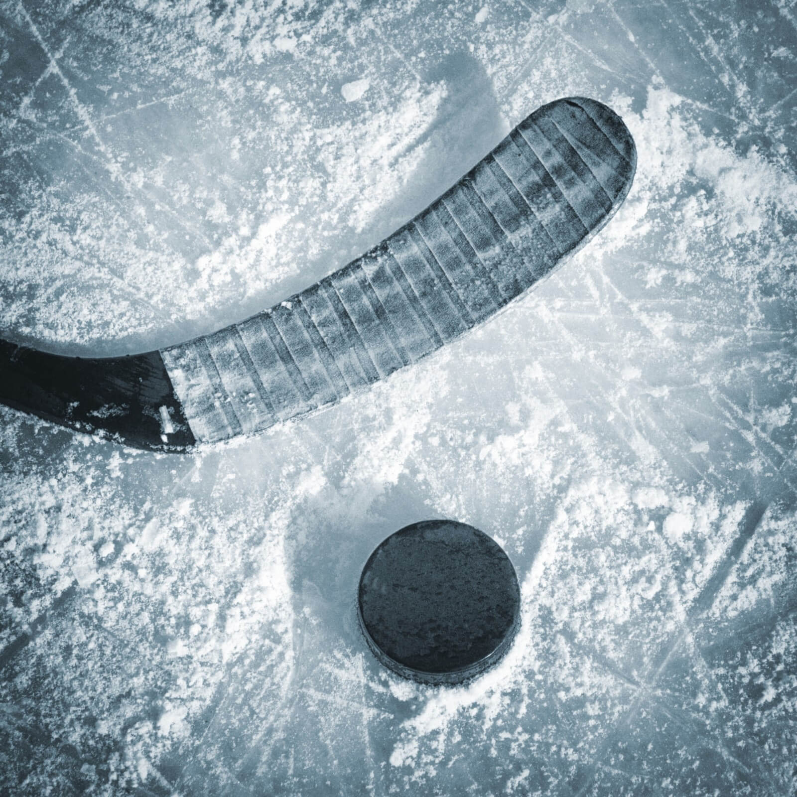 Black color hockey stick puck on ice